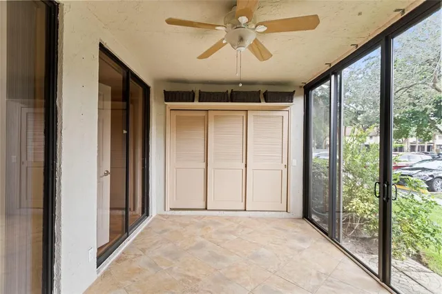a view of a livingroom with a ceiling fan and window