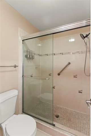 a bathroom with a toilet and a shower