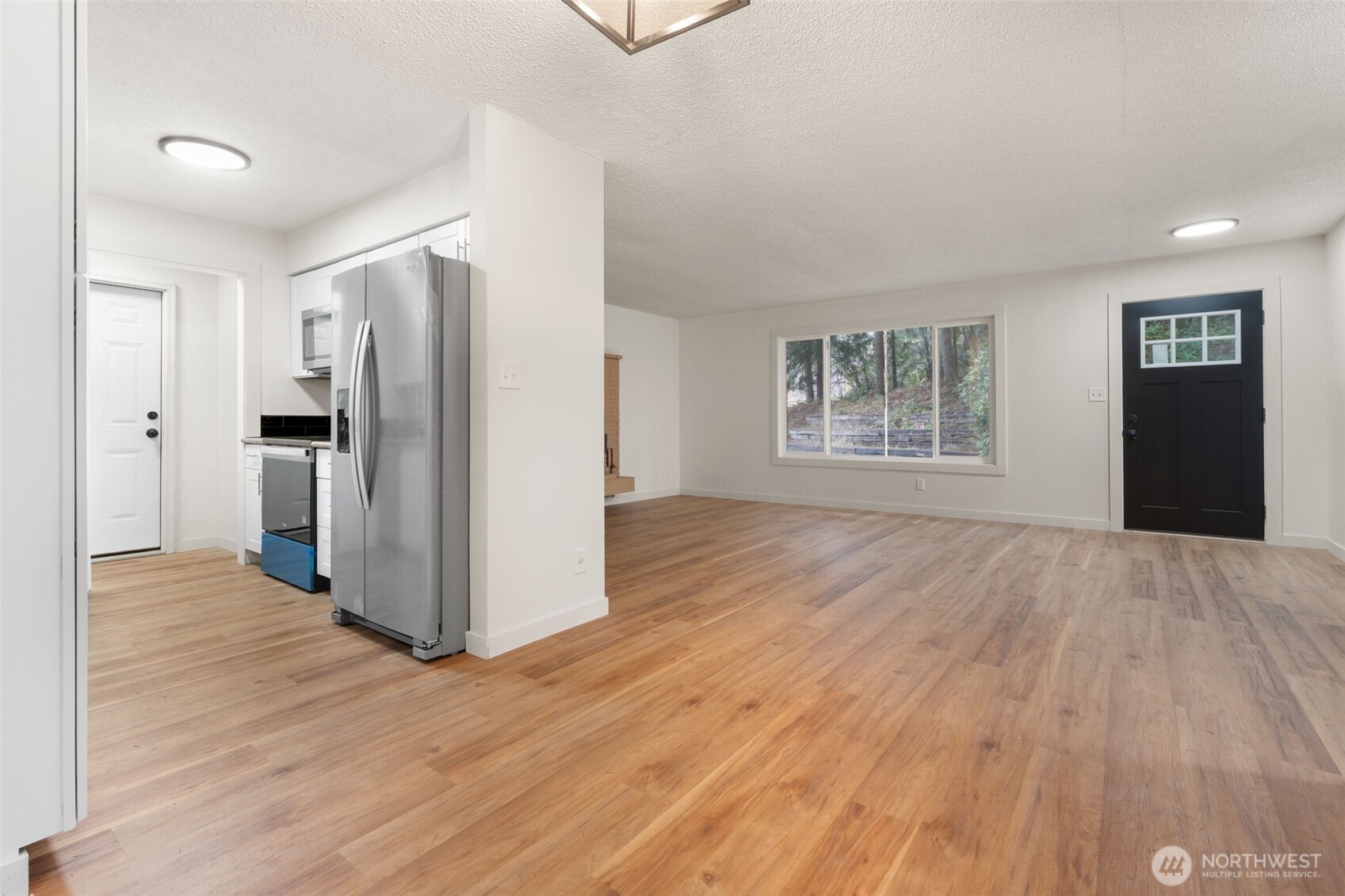 400 Ogden Road Castle Rock, WA 98611 - Photo 11 of 30 a view of a kitchen with refrigerator and wooden floor