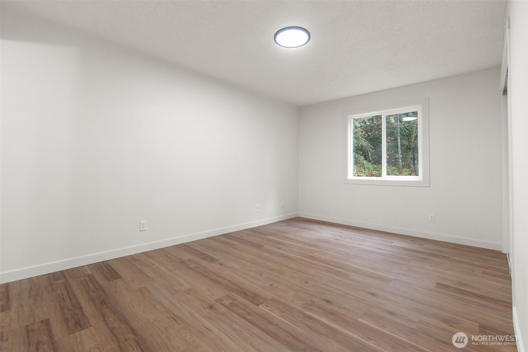 400 Ogden Road Castle Rock, WA 98611 - Photo 14 of 30 an empty room with wooden floor and windows