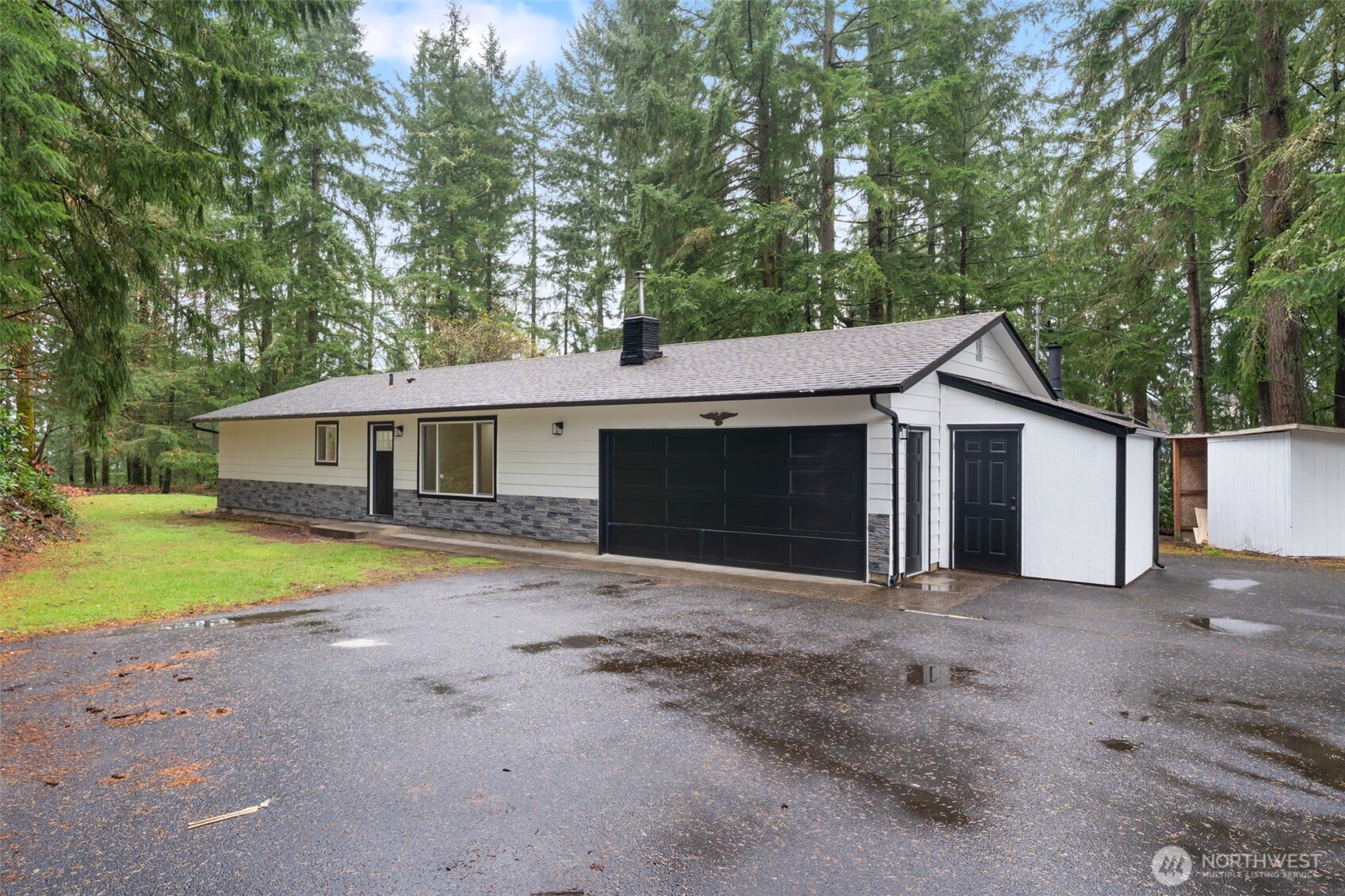 400 Ogden Road Castle Rock, WA 98611 - Photo 20 of 30 a front view of house with yard and trees in the background