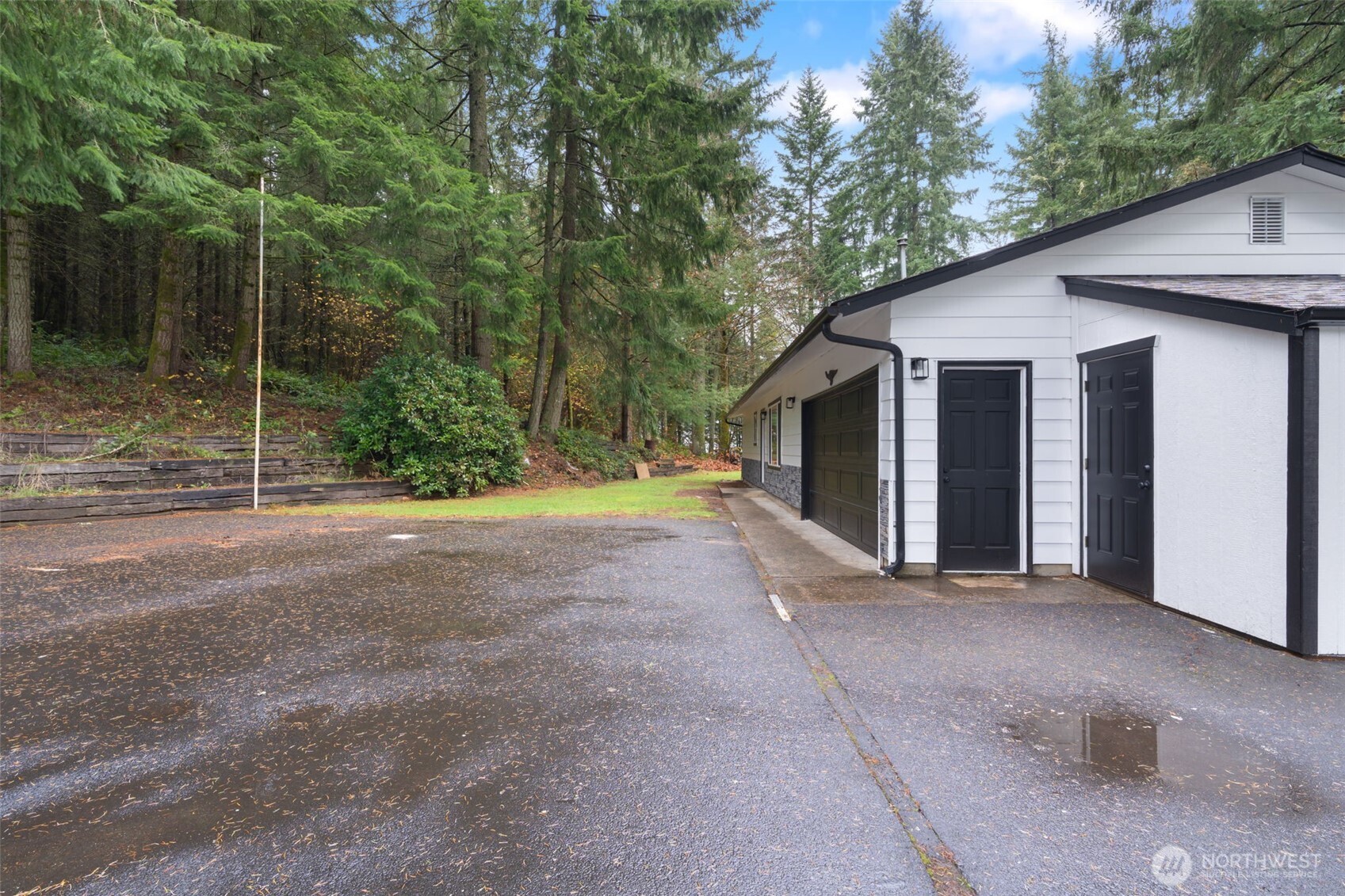 400 Ogden Road Castle Rock, WA 98611 - Photo 21 of 30 a view of a house with backyard and trees