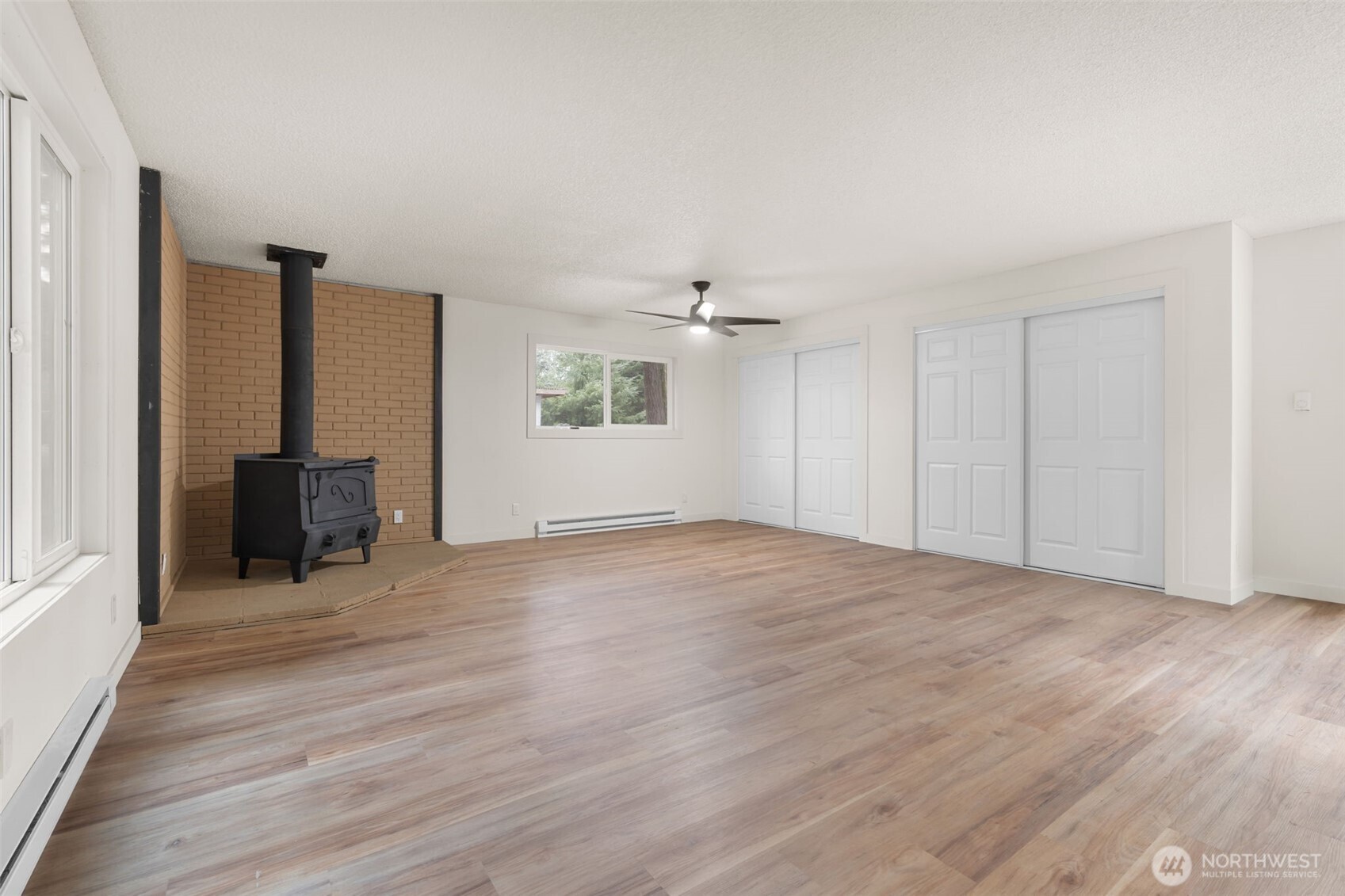 400 Ogden Road Castle Rock, WA 98611 - Photo 7 of 30 an empty room with wooden floor and windows