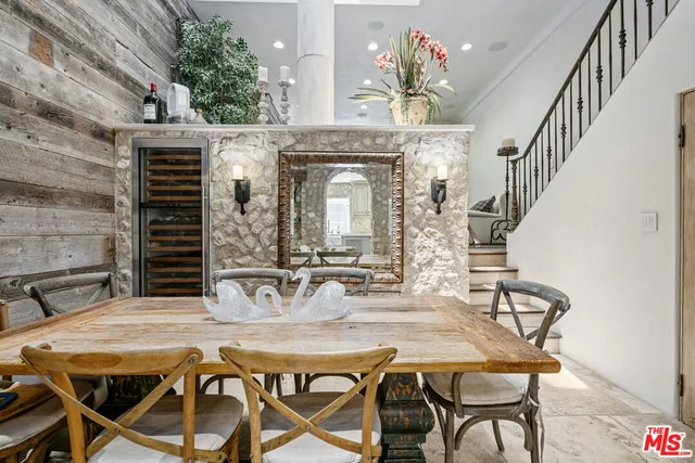 a view of a dining room with furniture and a chandelier