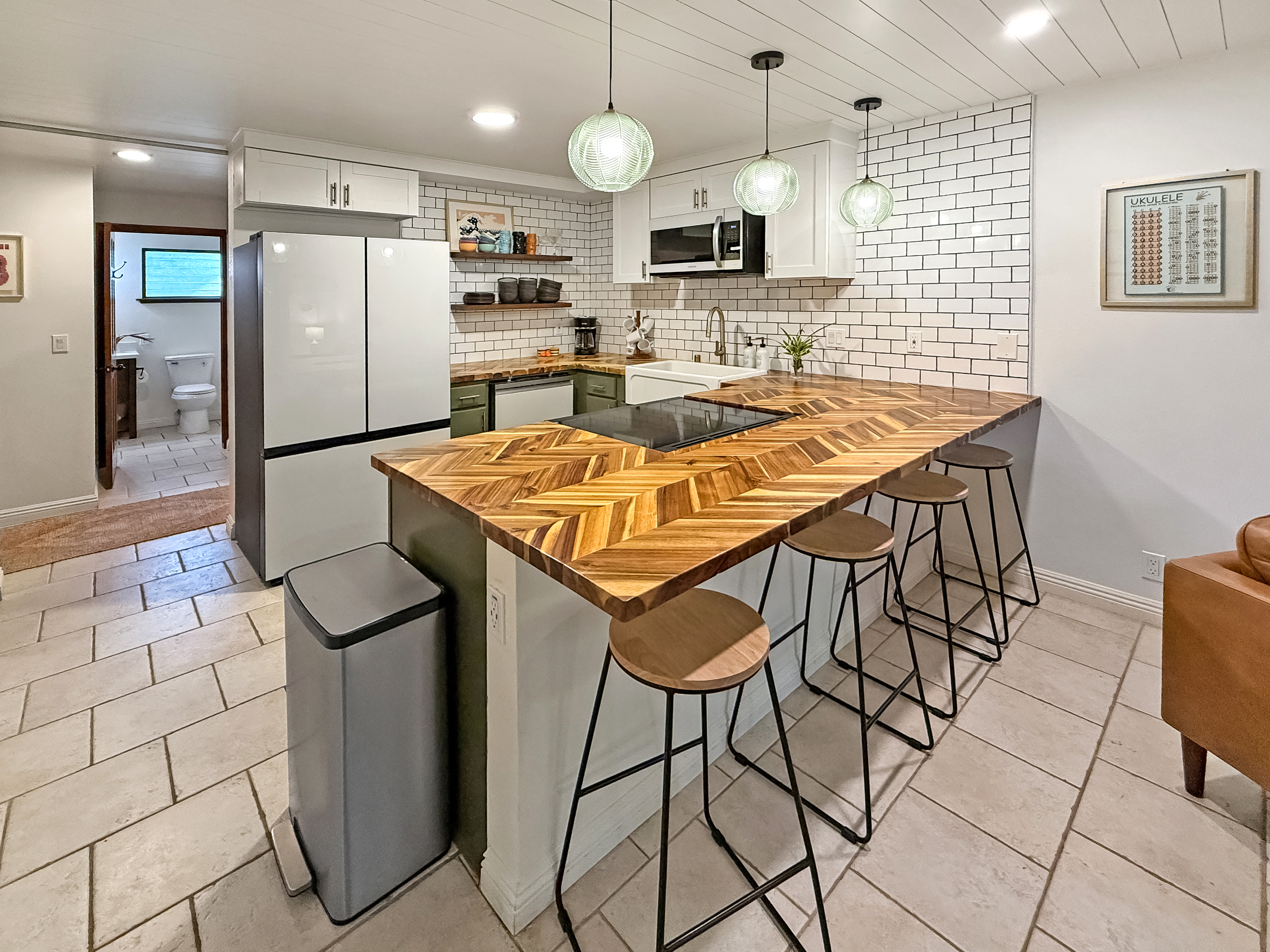 75-123 Lunapule Road, Unit 104 Kailua-Kona, HI 96740 - Photo 1 of 30 a kitchen with stainless steel appliances granite countertop a sink a stove a refrigerator cabinets and chairs