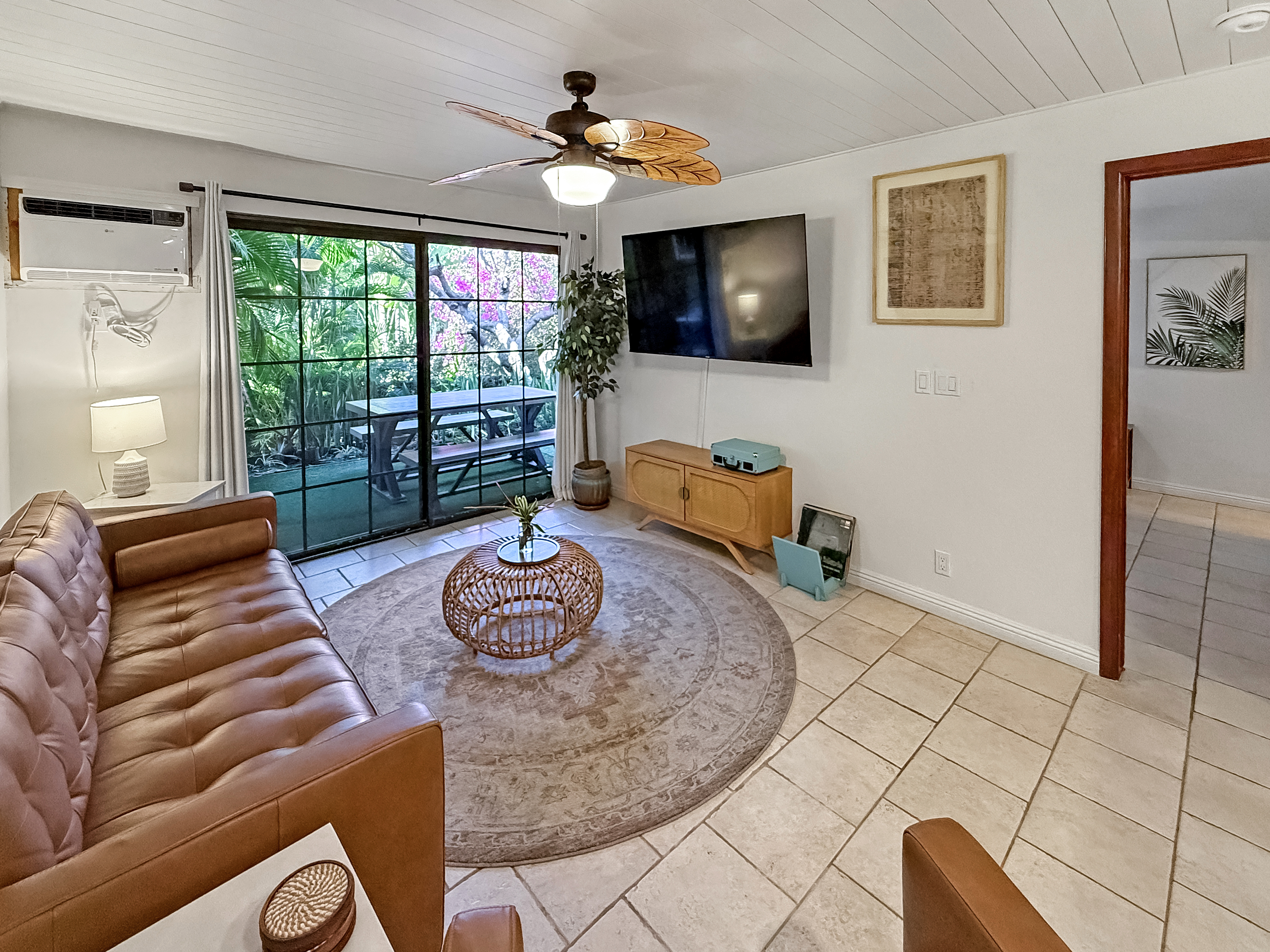 75-123 Lunapule Road, Unit 104 Kailua-Kona, HI 96740 - Photo 11 of 30 a living room with furniture and a flat screen tv