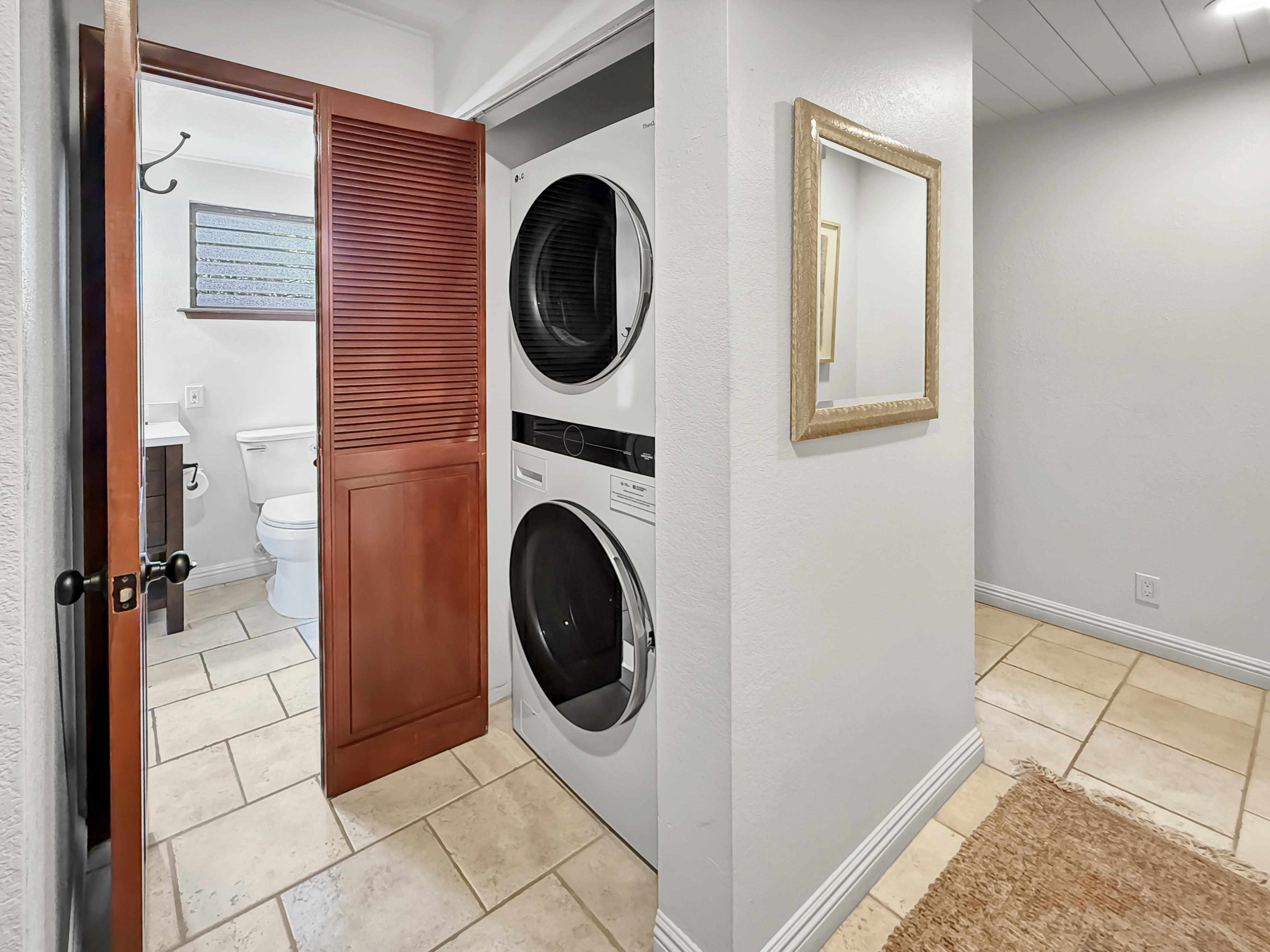 75-123 Lunapule Road, Unit 104 Kailua-Kona, HI 96740 - Photo 21 of 30 a view of a hallway with washer and dryer