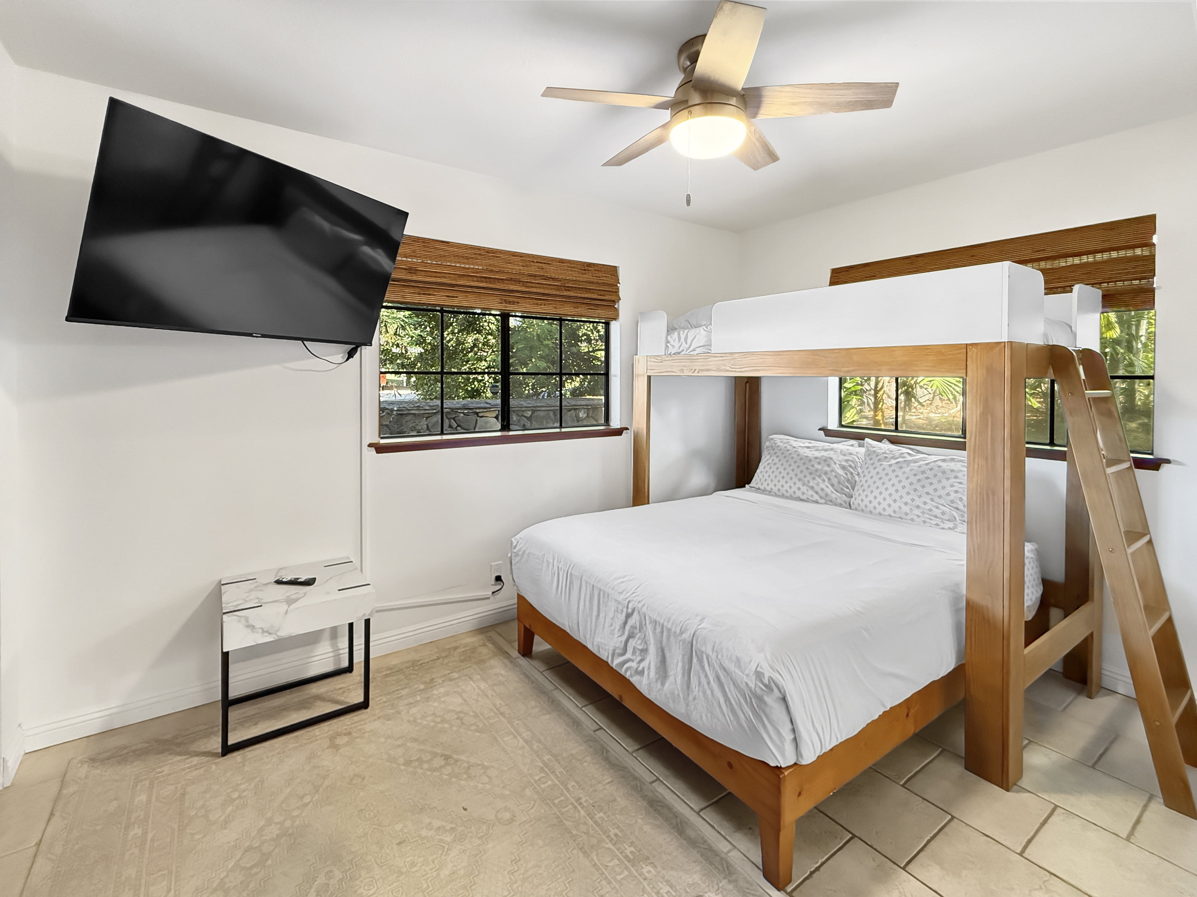 75-123 Lunapule Road, Unit 104 Kailua-Kona, HI 96740 - Photo 22 of 30 a bedroom with a bed and a flat tv screen on dresser