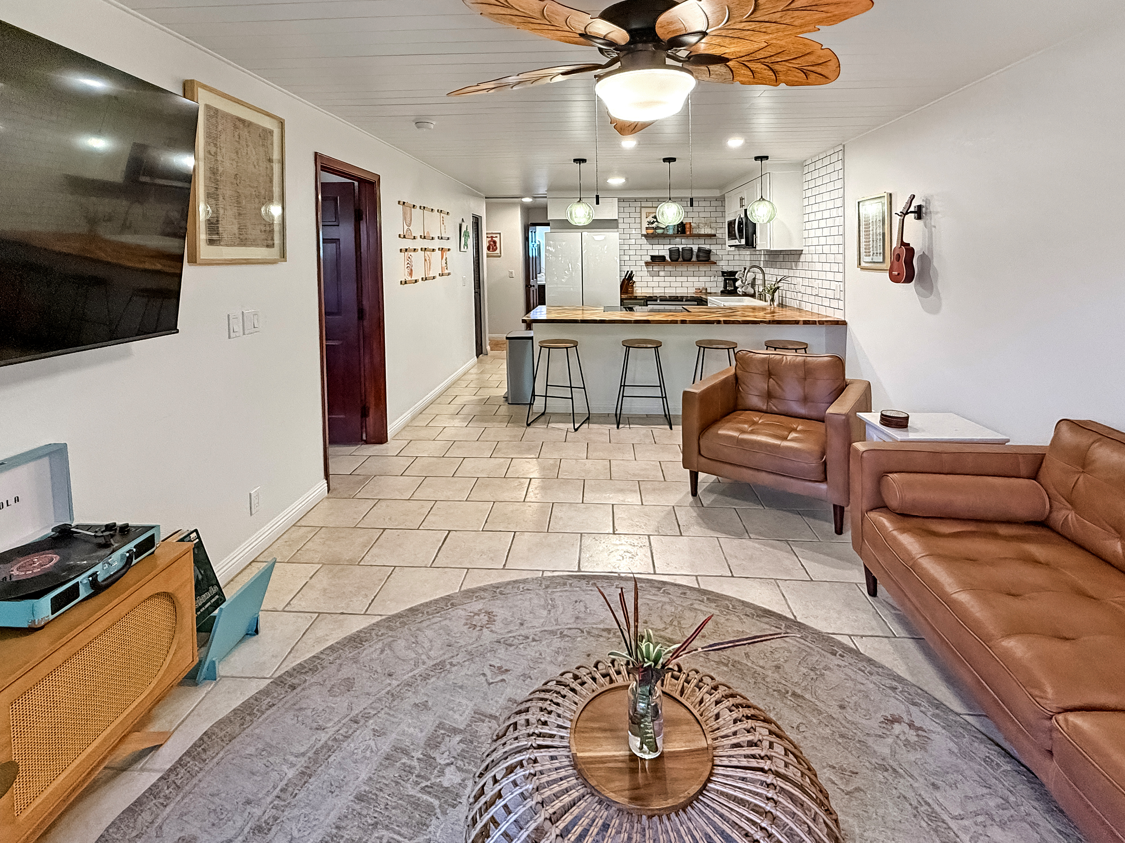 75-123 Lunapule Road, Unit 104 Kailua-Kona, HI 96740 - Photo 6 of 30 a living room with stainless steel appliances kitchen island granite countertop furniture and a view of kitchen