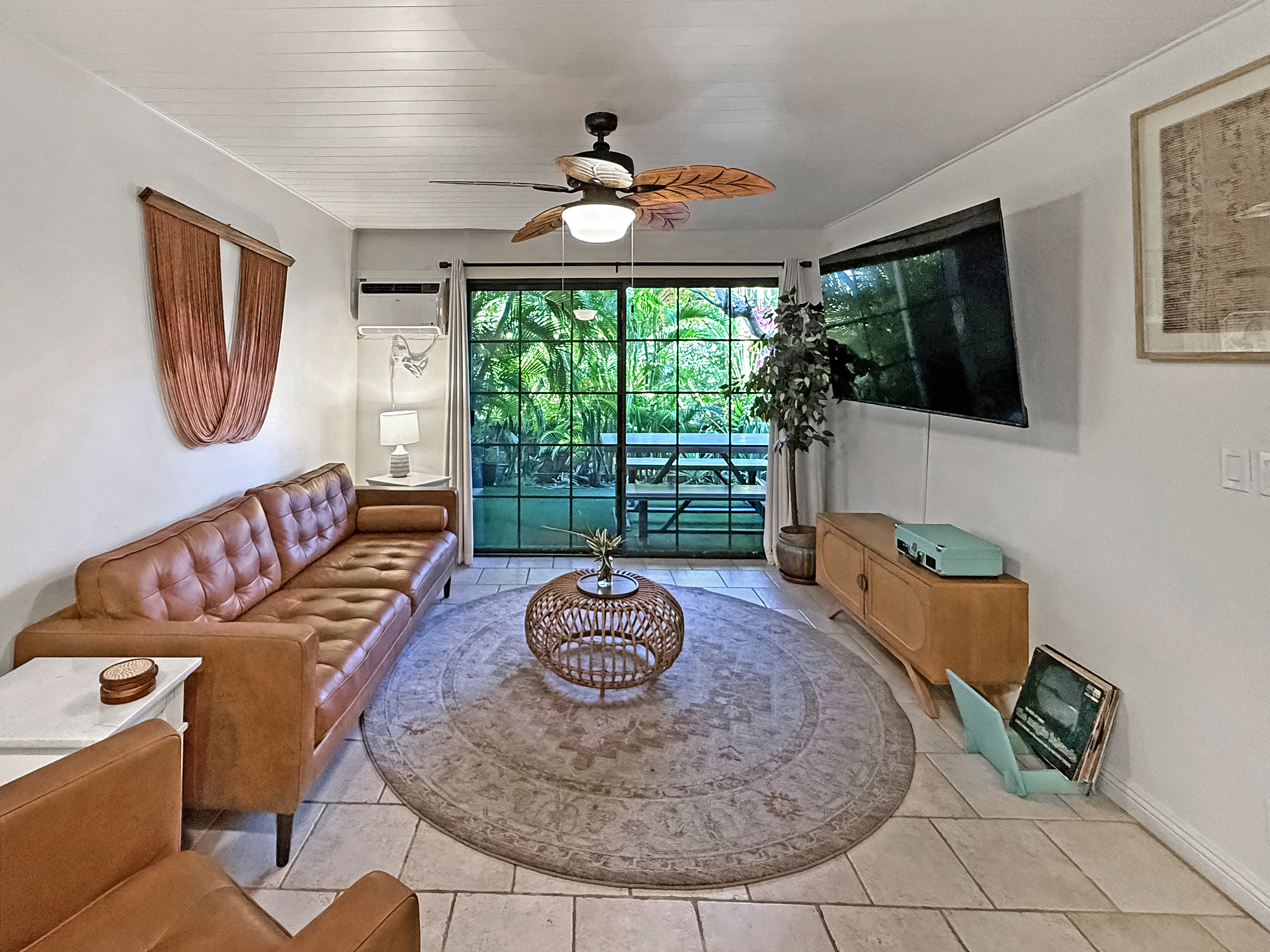 75-123 Lunapule Road, Unit 104 Kailua-Kona, HI 96740 - Photo 9 of 30 a living room with furniture and a floor to ceiling window