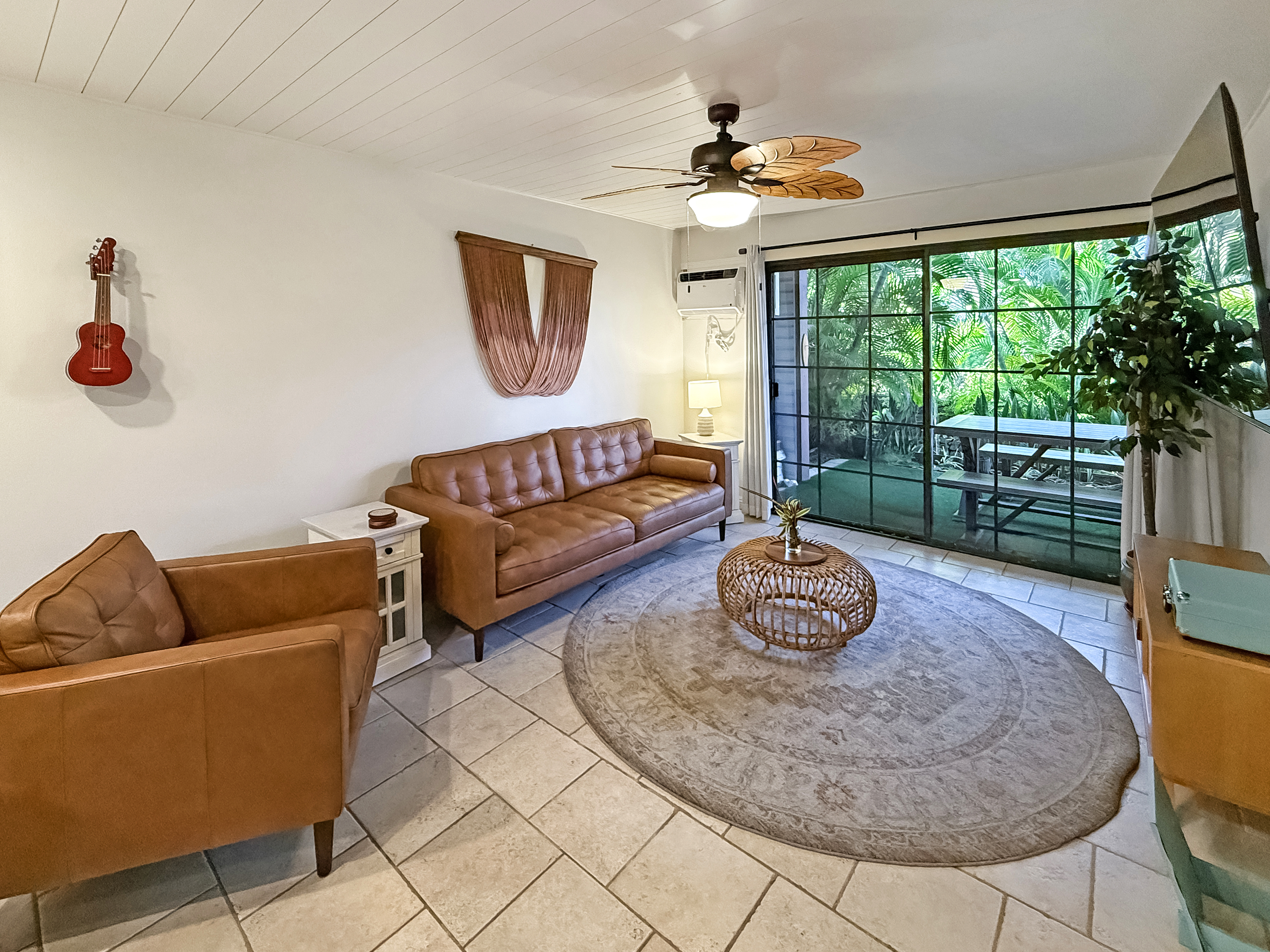 75-123 Lunapule Road, Unit 104 Kailua-Kona, HI 96740 - Photo 10 of 30 a living room with furniture and a large window