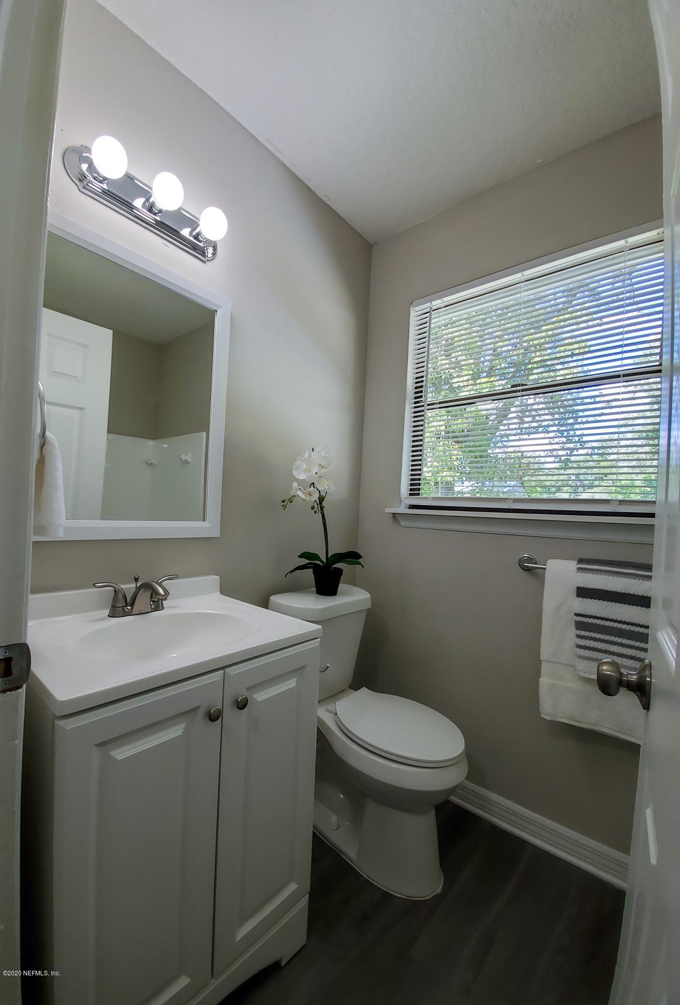 6929 Arques Road Jacksonville, FL 32205 - Photo 19 of 31 a bathroom with a toilet a sink and a mirror