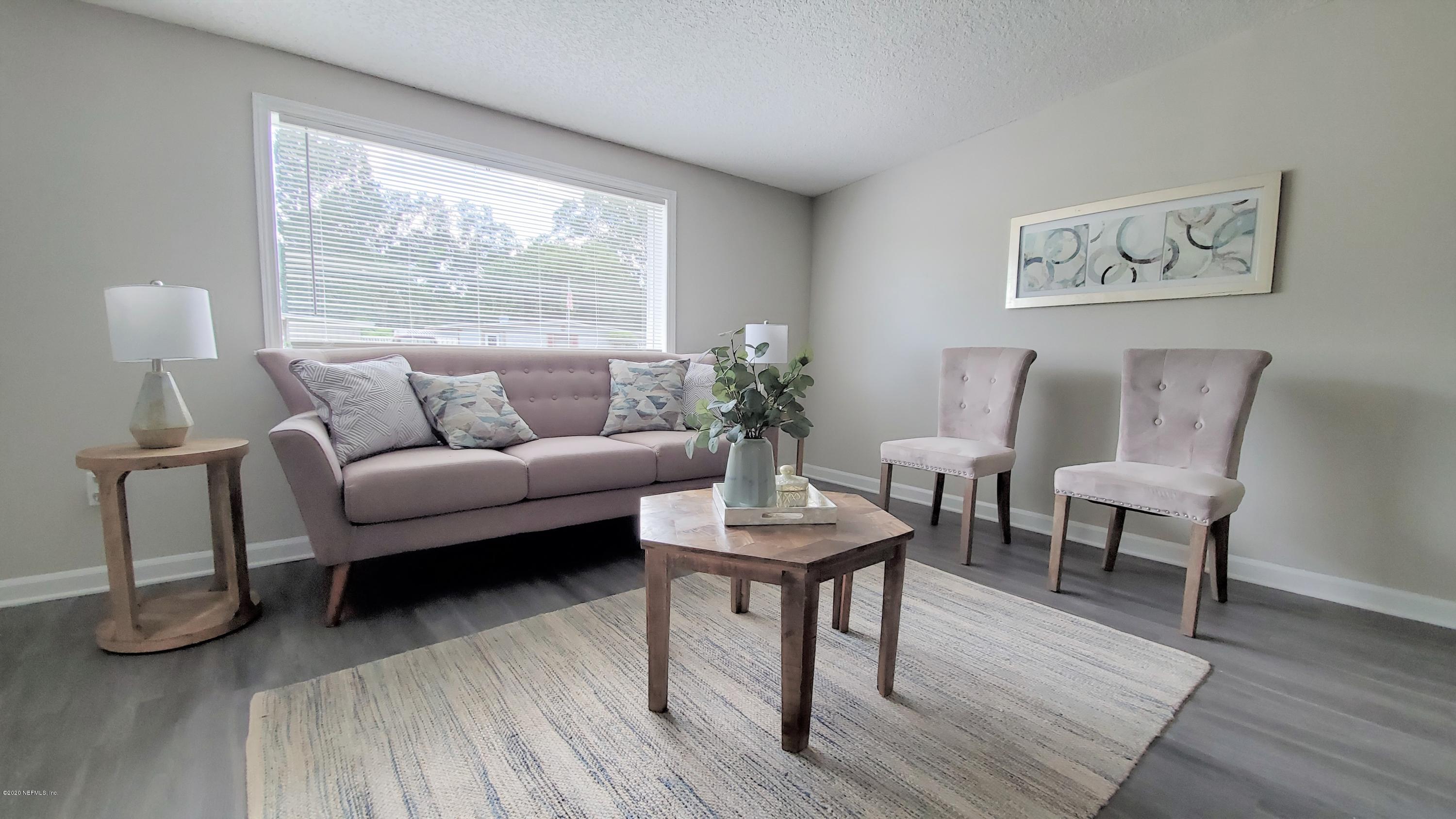 6929 Arques Road Jacksonville, FL 32205 - Photo 8 of 31 a living room with furniture and a potted plant