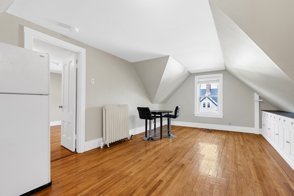 28 Evergreen Street, Unit 3 Boston, MA 02130 - Photo 6 of 16 an empty room with wooden floor and windows