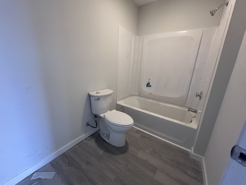 18 Marlborough Street, Unit 2L Chelsea, MA 02150 - Photo 2 of 7 a bathroom with a toilet a sink and a shower