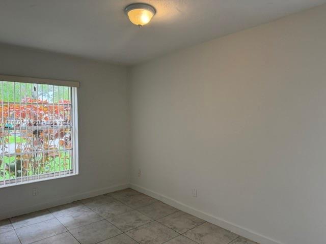 11206 Southwest 125th Place, Unit 11206 Miami, FL 33186 - Photo 11 of 15 an empty room with windows