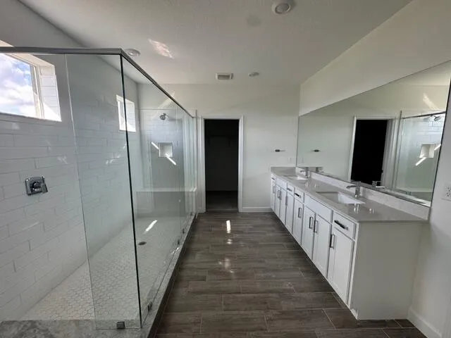a bathroom with a double vanity sink and mirror