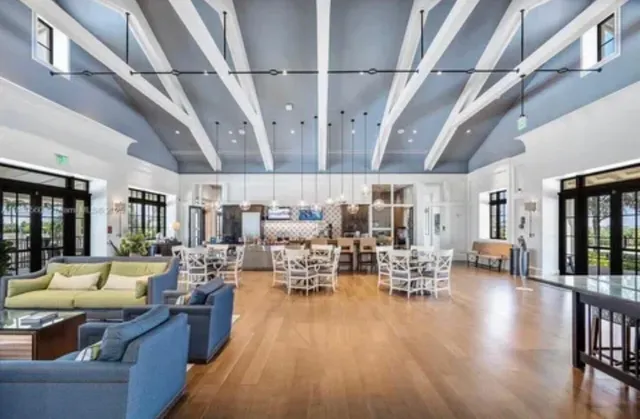 a living room with lots of furniture and a chandelier