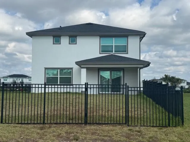 a view of a house with a small yard and plants