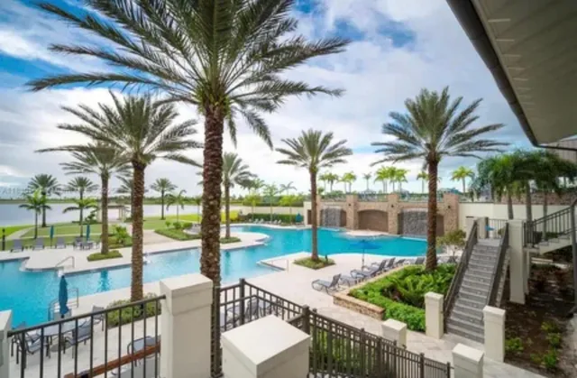 a view of swimming pool with outdoor seating and city view