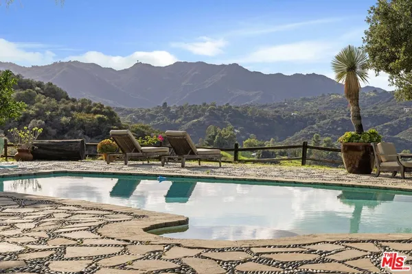 a view of a swimming pool with a lake view and mountain view