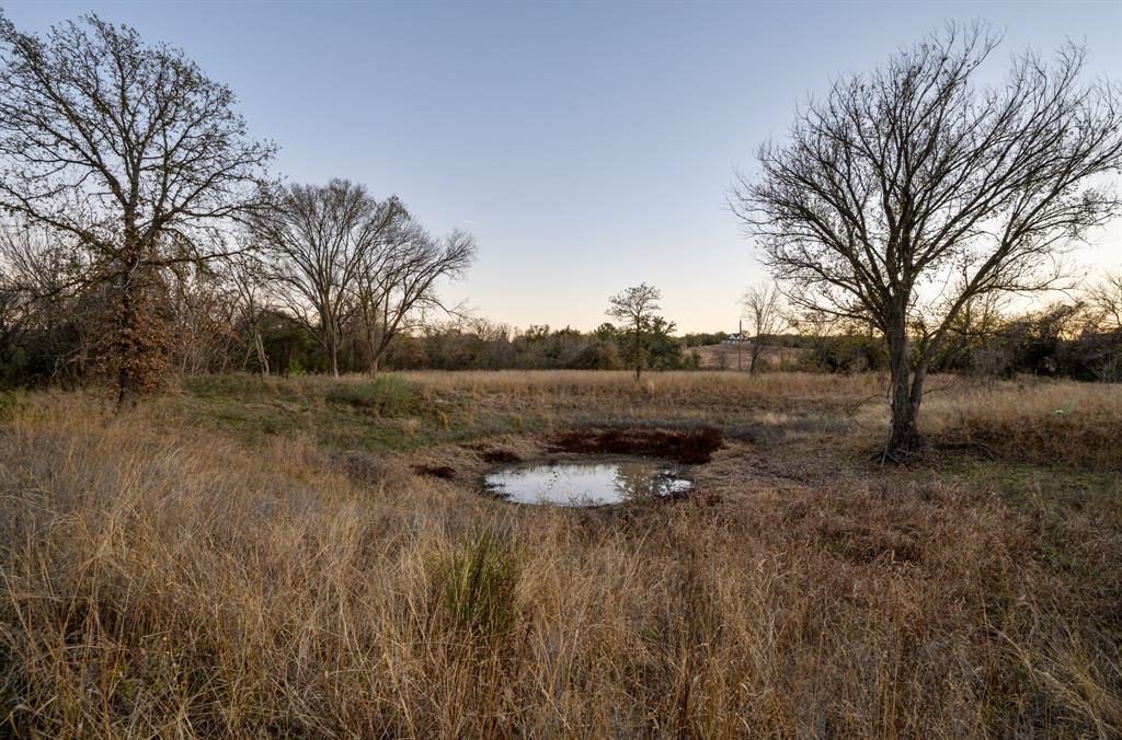 1874 County Road 3676 Springtown, TX 76082 - Photo 4 of 14 a backyard of a house with trees and wooden fence