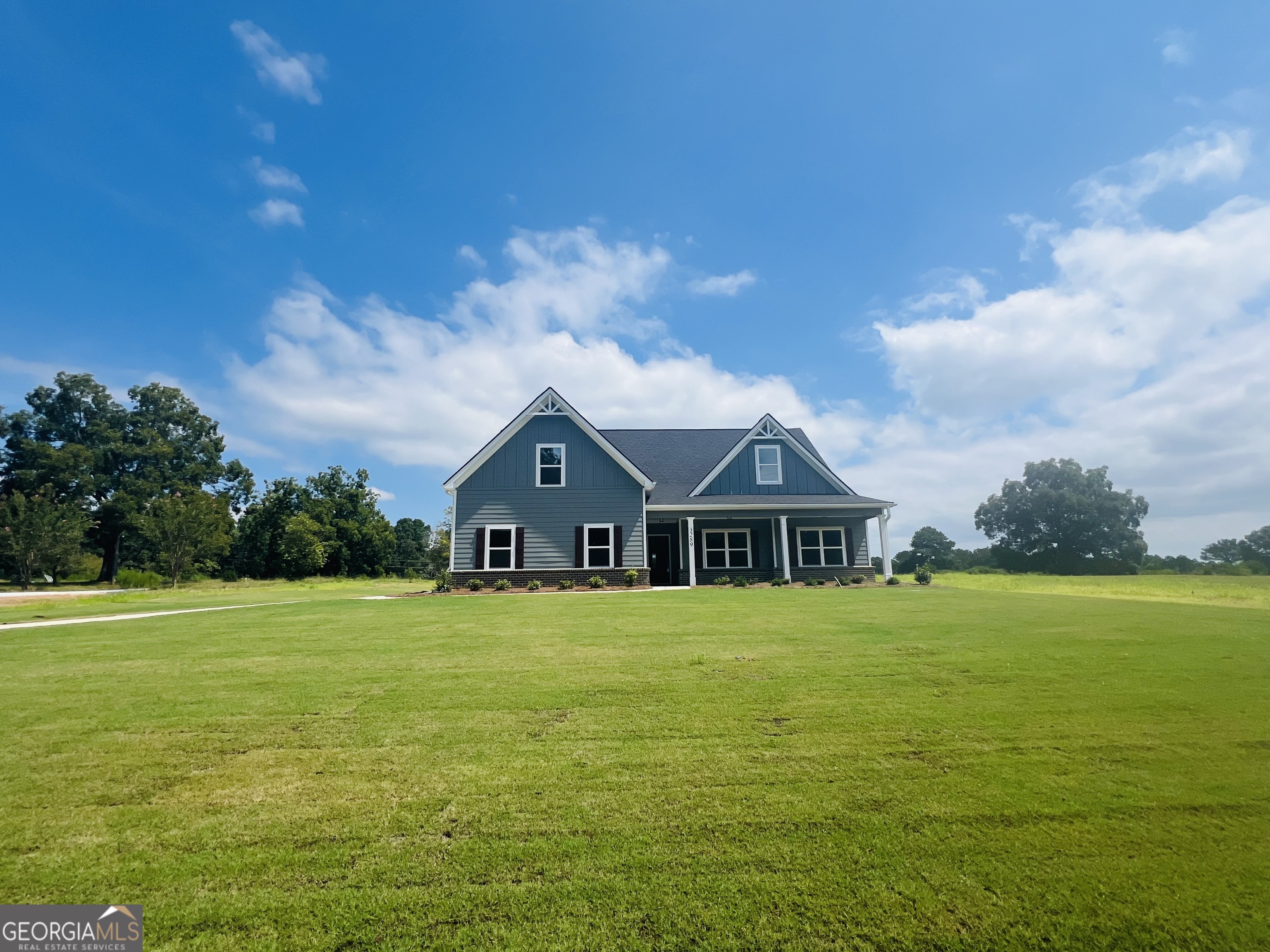 3289 Old Jackson Road, Unit 3 Locust Grove, GA 30248 - Photo 1 of 1 a front view of a house with a big yard