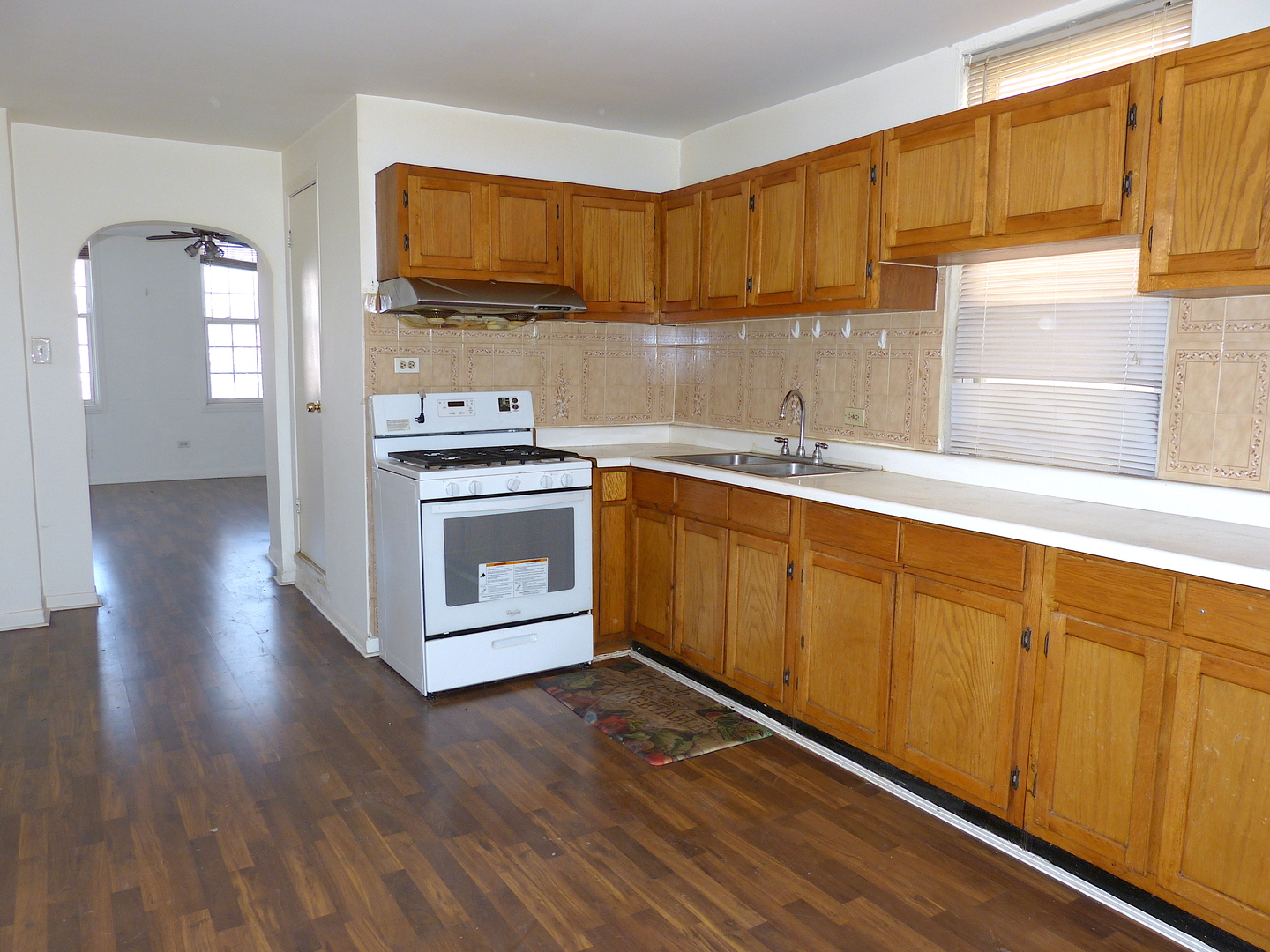 1617 West 38th Place Chicago, IL 60609 - Photo 11 of 18 a kitchen with sink cabinets and wooden floor