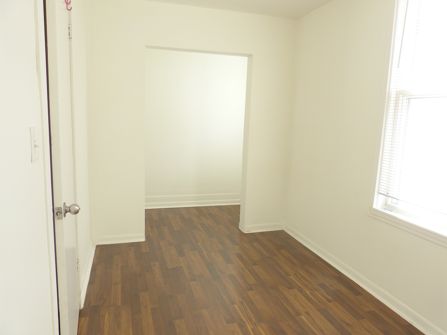 1617 West 38th Place Chicago, IL 60609 - Photo 13 of 18 a view of a small space with wooden floor and a window