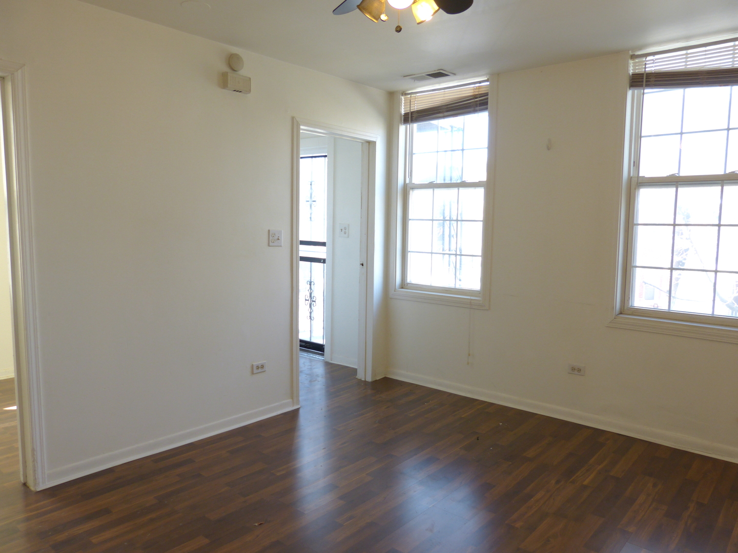 1617 West 38th Place Chicago, IL 60609 - Photo 4 of 18 an empty room with wooden floor and windows