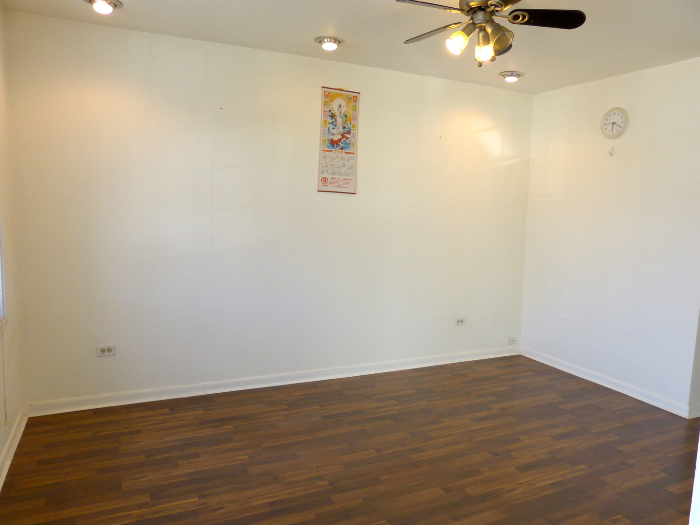 1617 West 38th Place Chicago, IL 60609 - Photo 5 of 18 an empty room with wooden floor and a ceiling fan