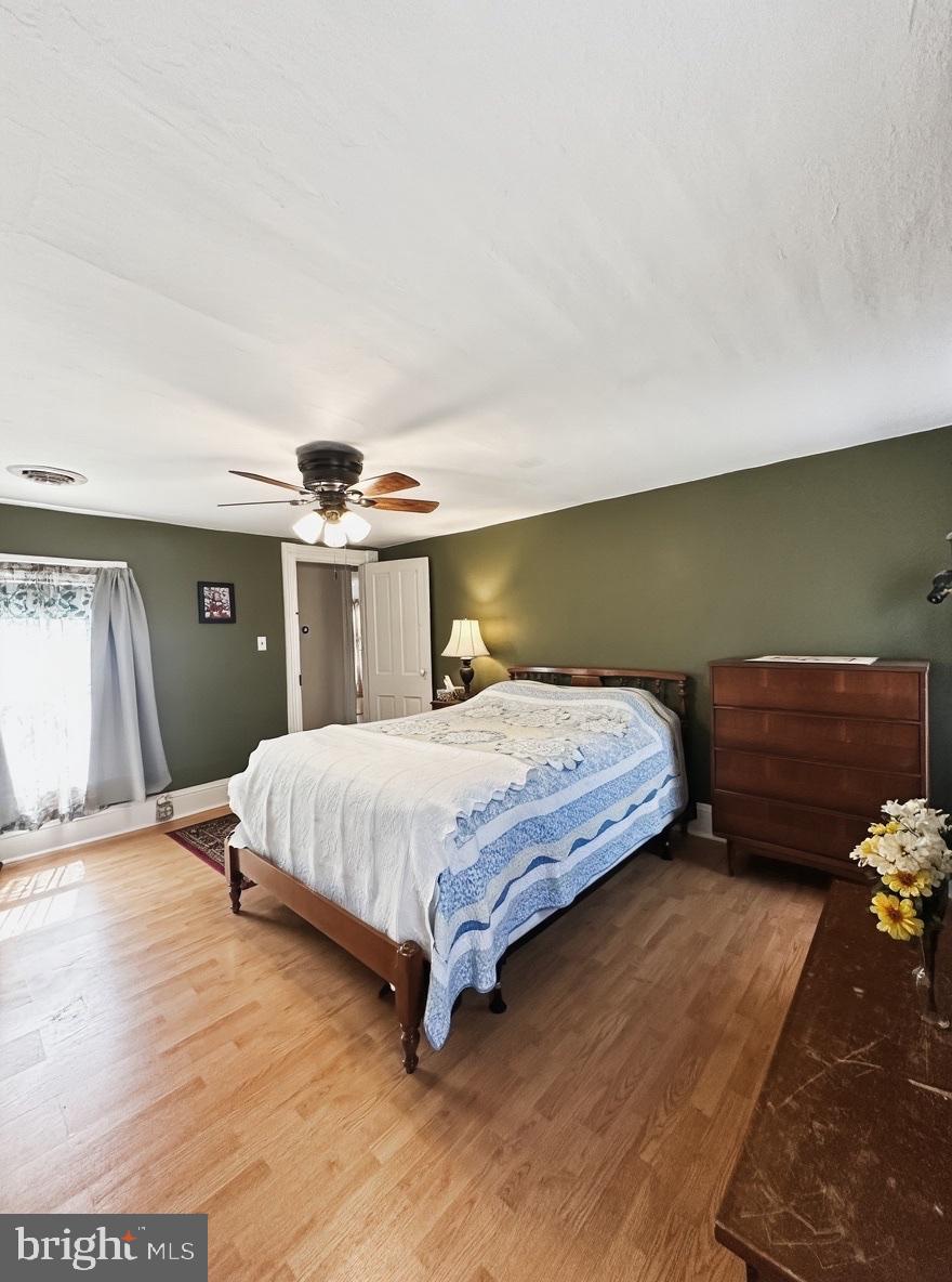 36 Martin Diggs Way Onemo, VA 23130 - Photo 32 of 64 a bedroom with a bed and wooden floor