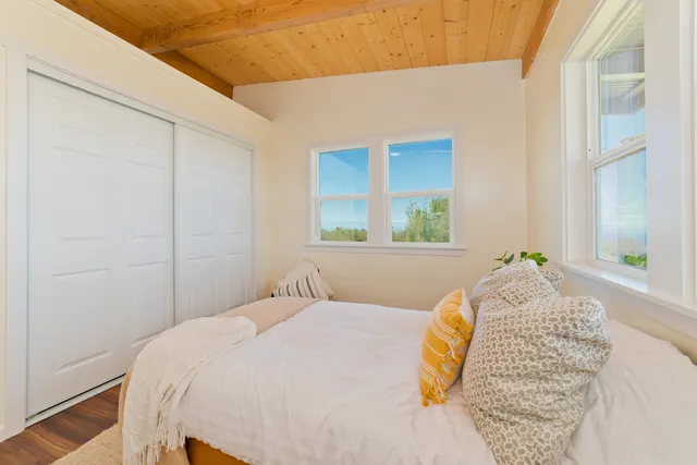 a bedroom with a bed and a window