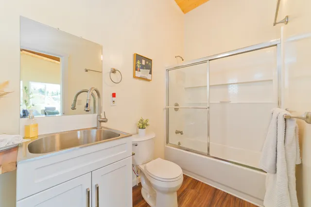 a bathroom with a sink a toilet and shower