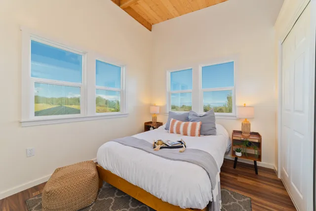 a bedroom with a bed and a window