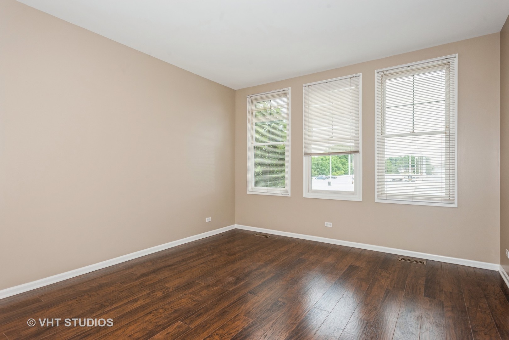 224 Lake Street Elgin, IL 60120 - Photo 11 of 20 an empty room with wooden floor and windows