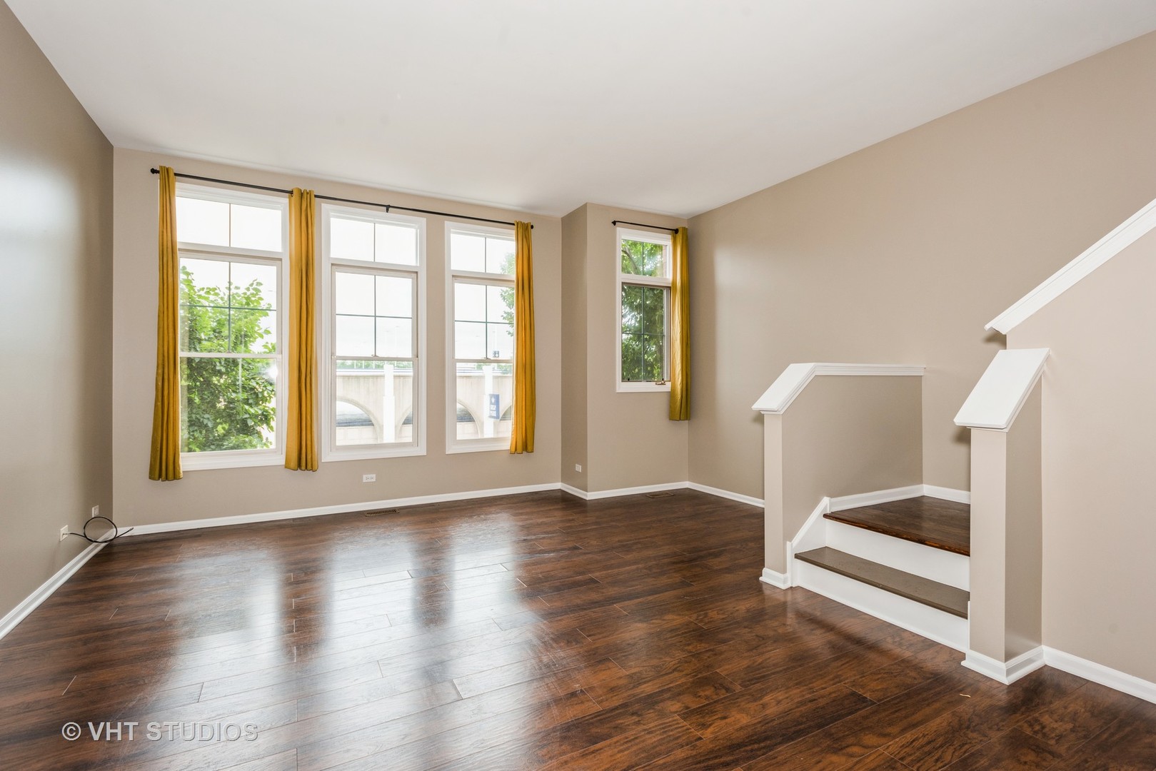 224 Lake Street Elgin, IL 60120 - Photo 7 of 20 an empty room with wooden floor and windows