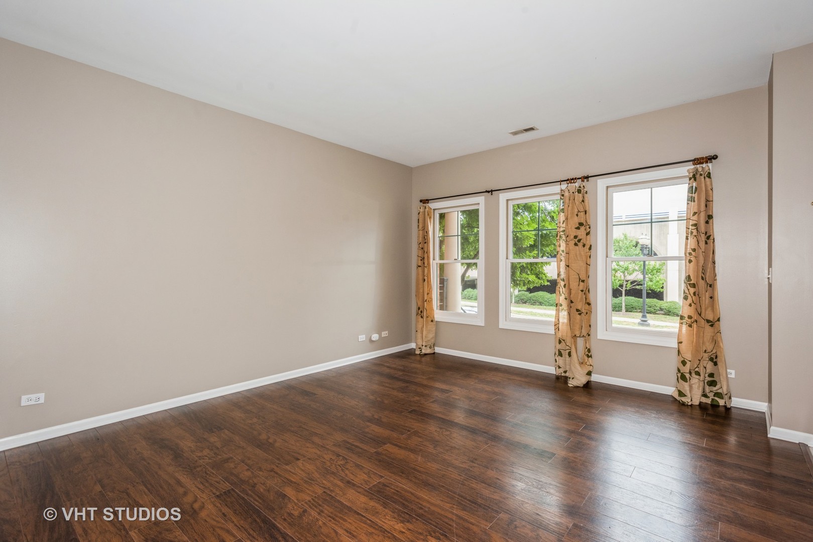 224 Lake Street Elgin, IL 60120 - Photo 8 of 20 a view of an empty room with wooden floor and a window