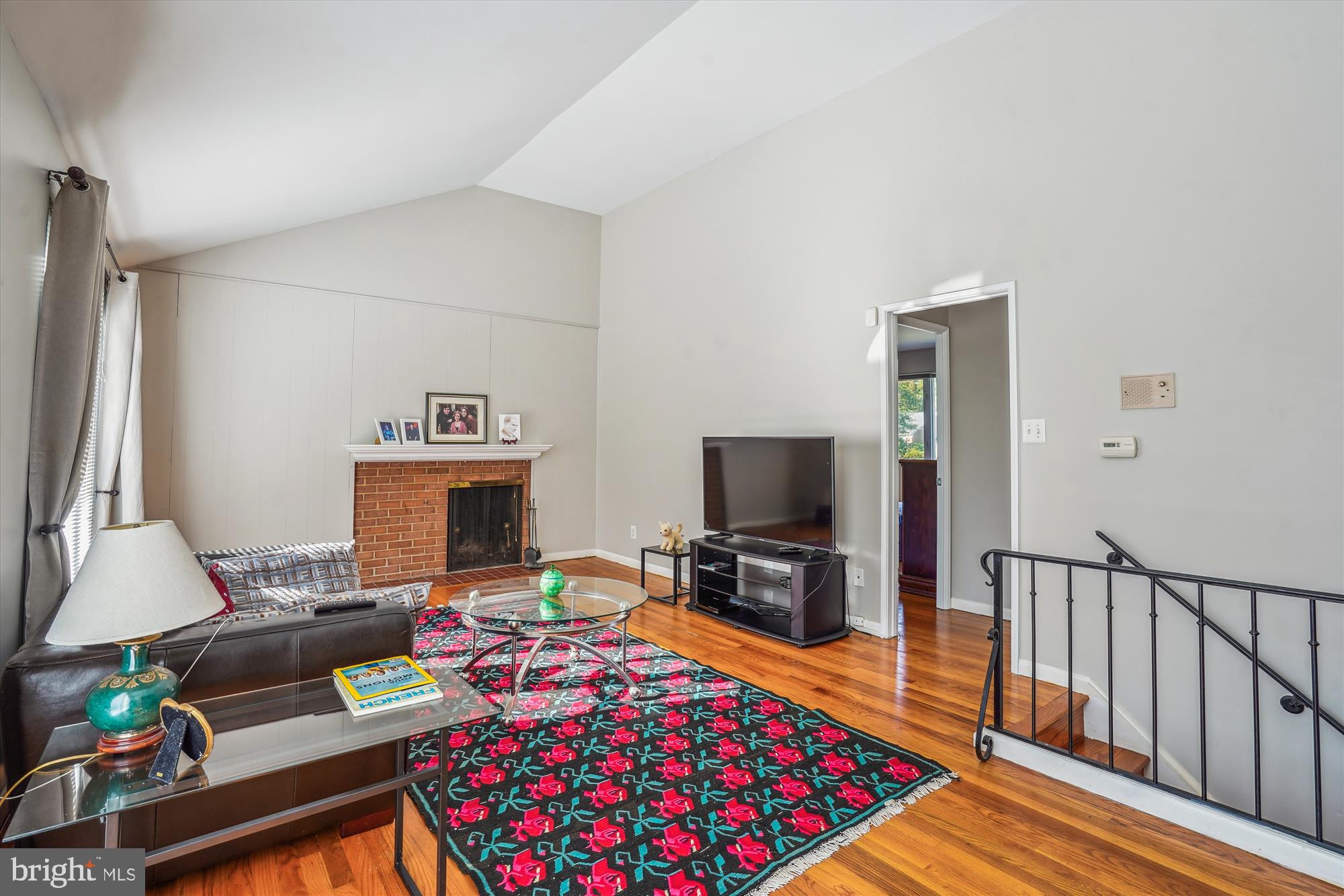 1803 Rupert Street McLean, VA 22101 - Photo 12 of 20 a living room with furniture a flat screen tv and a fireplace