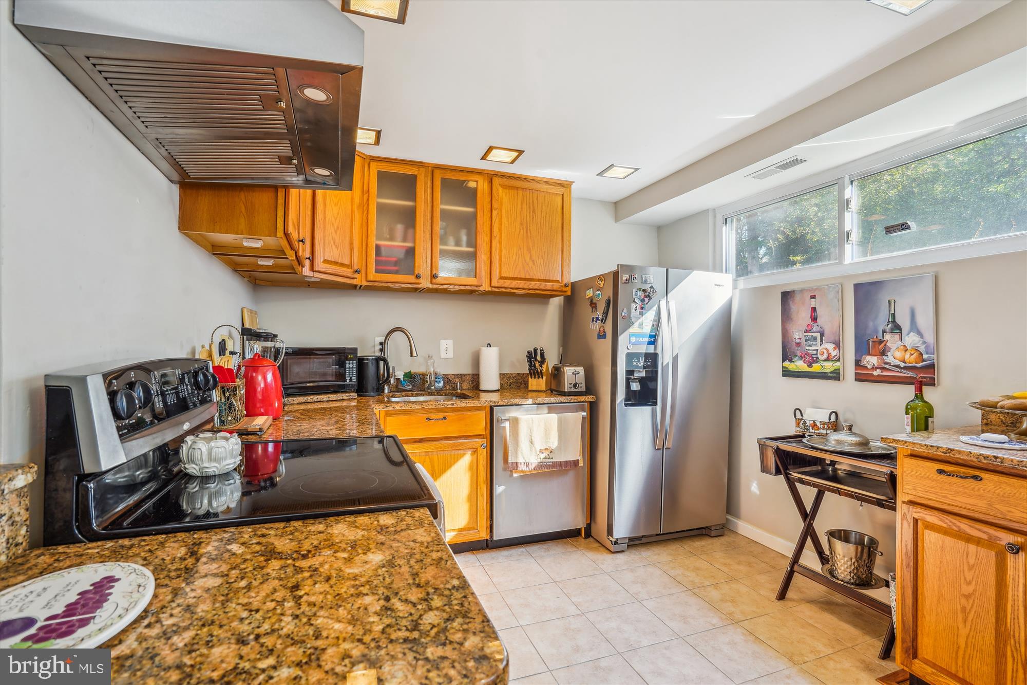 1803 Rupert Street McLean, VA 22101 - Photo 4 of 20 a kitchen with stainless steel appliances granite countertop a refrigerator and stove