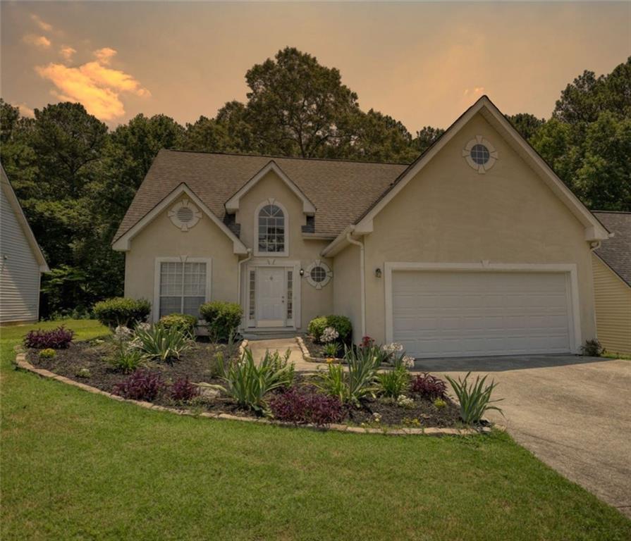 a front view of a house with a yard and garage