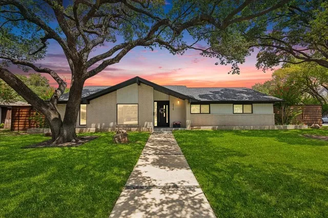 a front view of a house with yard