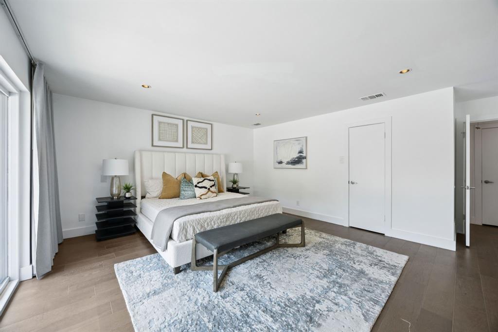 4925 Sugar Mill Road Dallas, TX 75244 - Photo 16 of 22 a bedroom with a bed and a rug