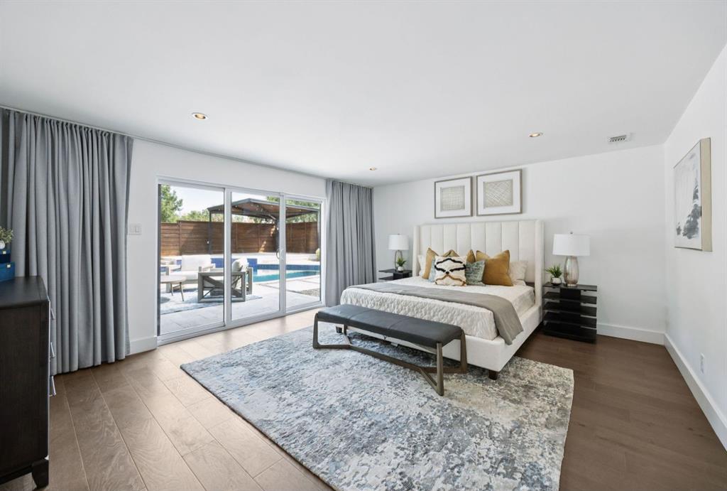 4925 Sugar Mill Road Dallas, TX 75244 - Photo 17 of 22 a spacious bedroom with a bed a table and large window