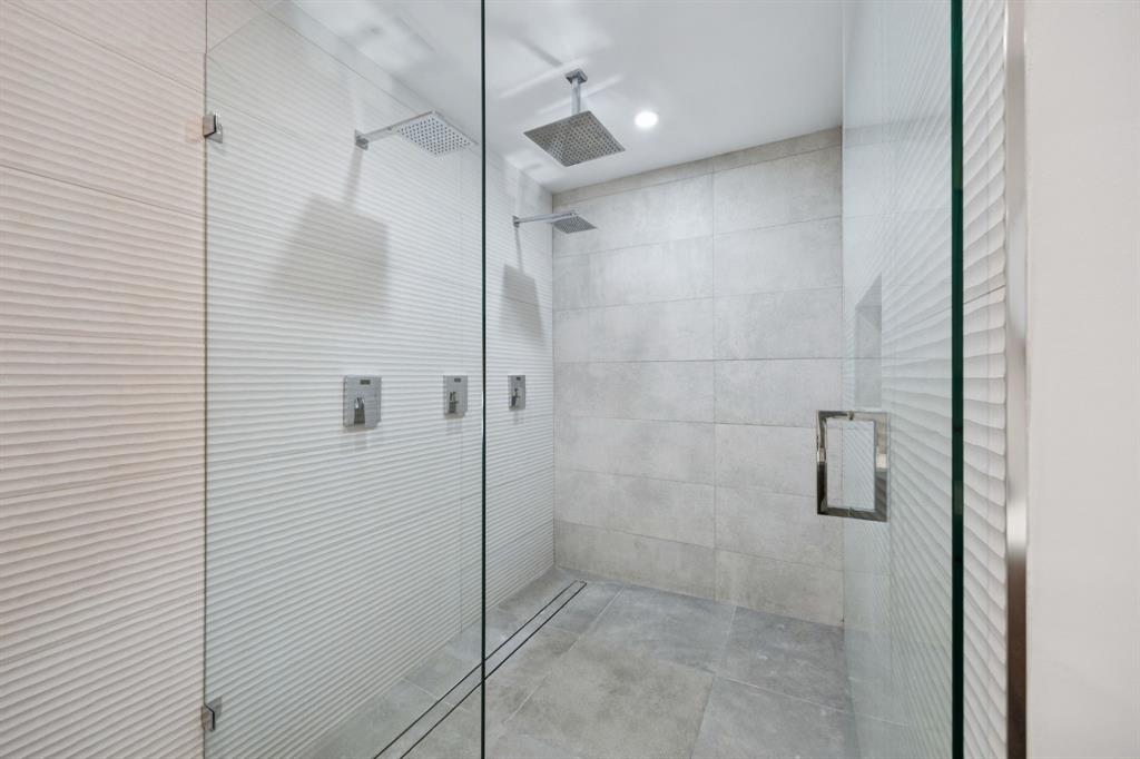 4925 Sugar Mill Road Dallas, TX 75244 - Photo 19 of 22 a bathroom with a shower and a glass door
