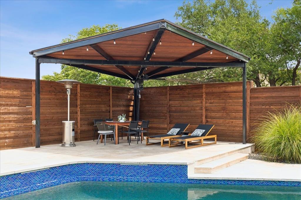 4925 Sugar Mill Road Dallas, TX 75244 - Photo 21 of 22 a view of a patio with table and chairs under an umbrella