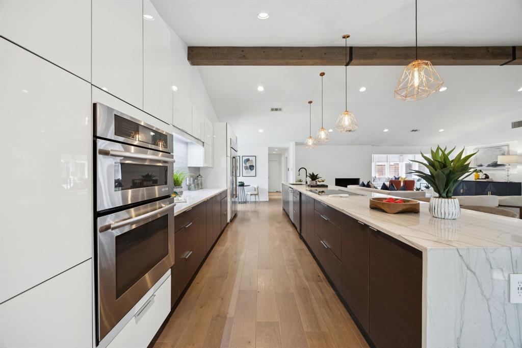 4925 Sugar Mill Road Dallas, TX 75244 - Photo 5 of 22 a large kitchen with a large counter top cabinets and stainless steel appliances