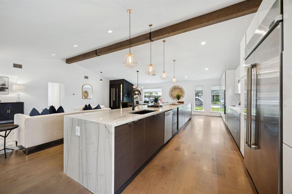 4925 Sugar Mill Road Dallas, TX 75244 - Photo 6 of 22 a kitchen with stainless steel appliances kitchen island a refrigerator sink and cabinets