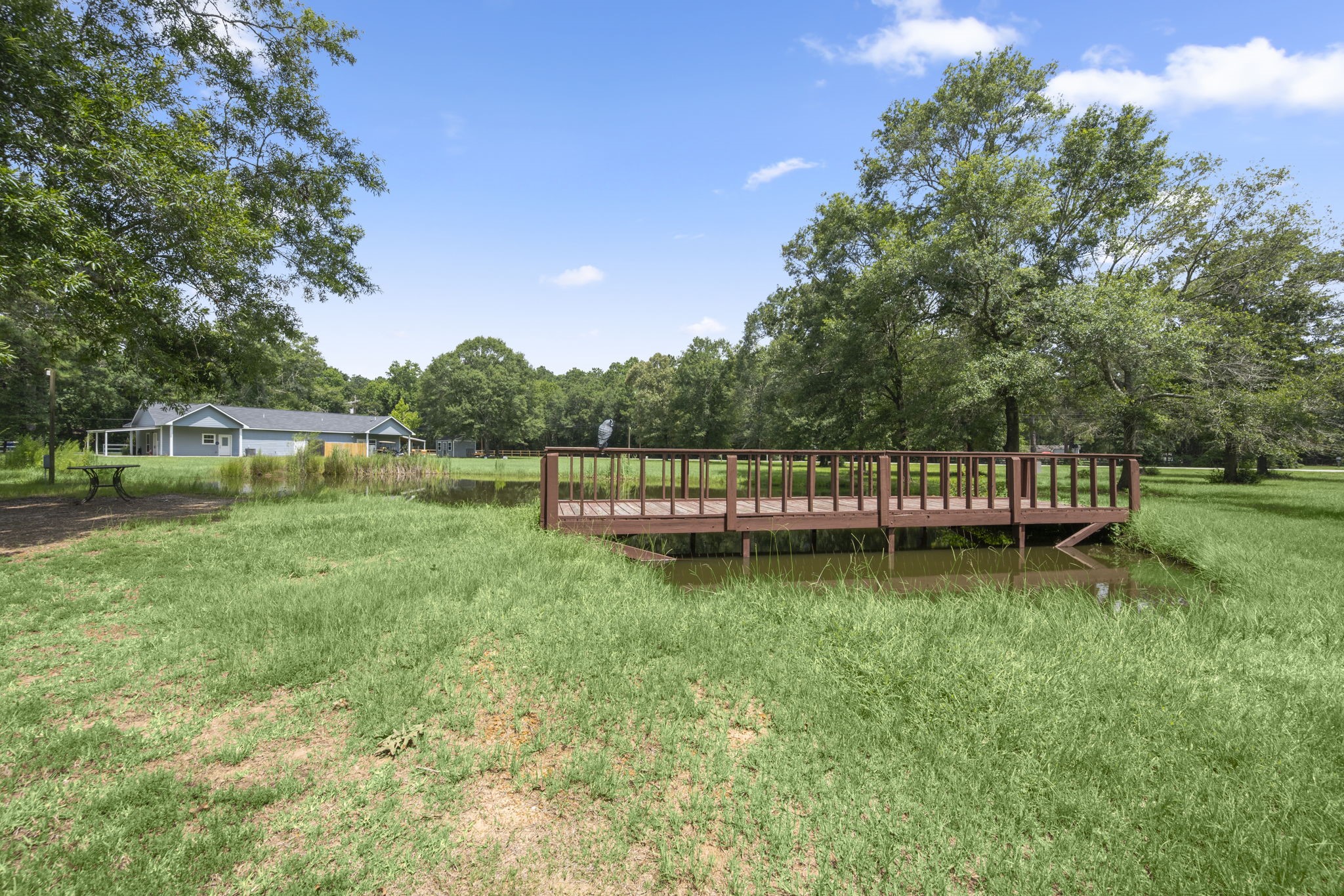 10871 Coaster Lane Conroe, TX 77306 - Photo 32 of 37 Per seller the water below the bridge is several feet deep. Nice hole for the catfish to hang out.