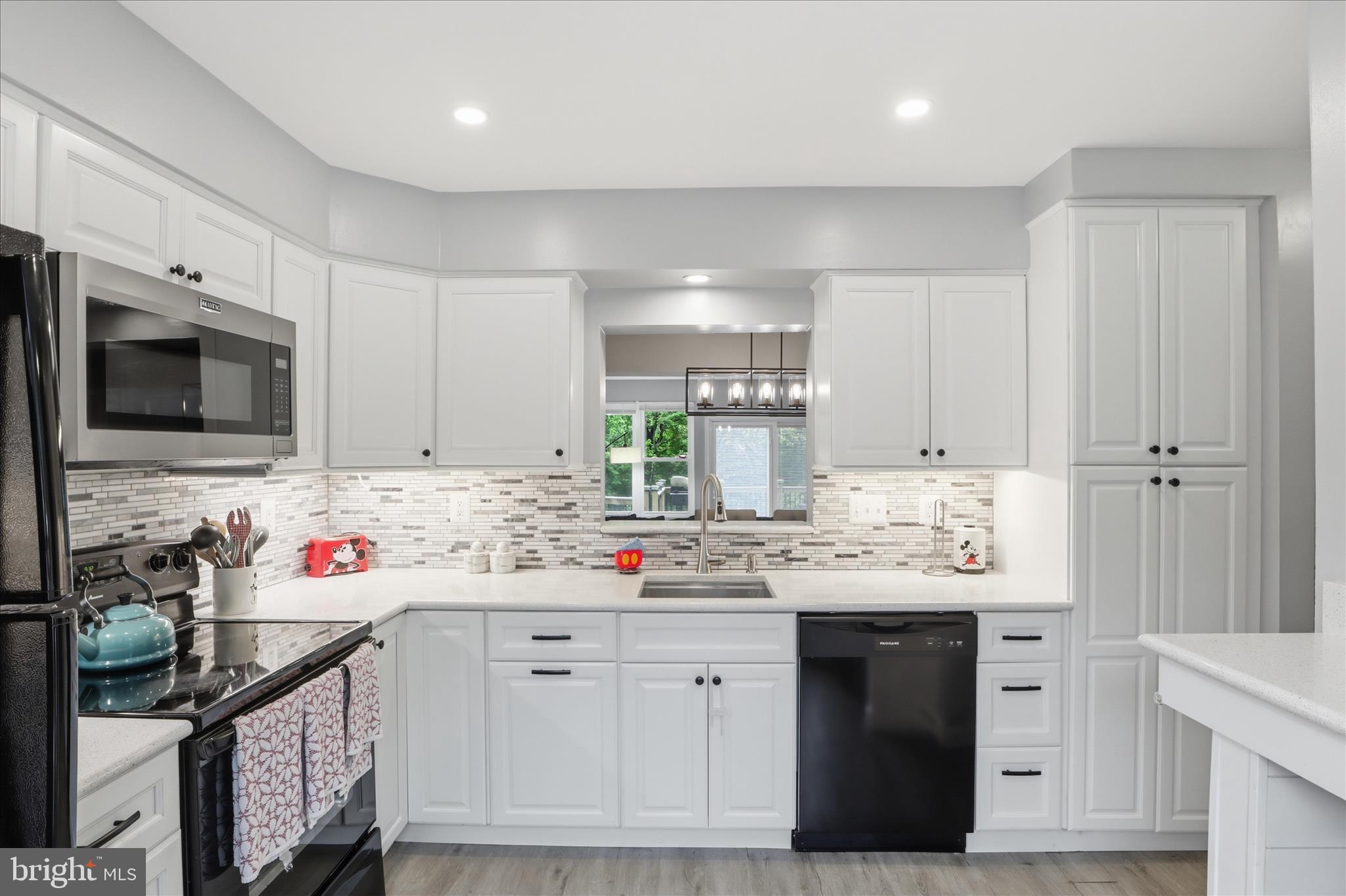 71 Kinsman View Circle Silver Spring, MD 20901 - Photo 7 of 42 a kitchen with a sink stove top oven and cabinets
